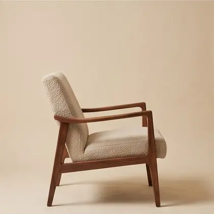 Walnut-framed lounge chair in oatmeal bouclé, rotated 90 degrees.