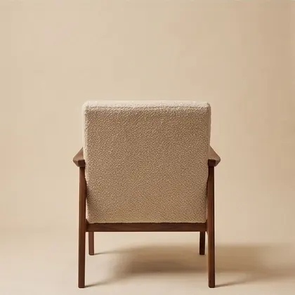Walnut-framed lounge chair in oatmeal bouclé, rotated 180 degrees.