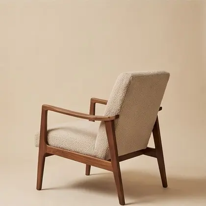Walnut-framed lounge chair in oatmeal bouclé, rotated 315 degrees.